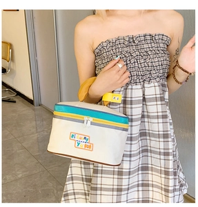 Detailed view of white canvas house-shaped makeup bag with Ri Guang Yu embroidery