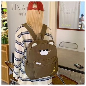 Detail of cute brown bear canvas backpack showing adjustable straps and back fit