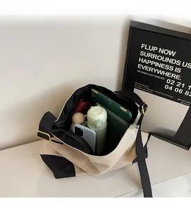 Top view of spacious interior of canvas tote bag filled with gadgets and bottles