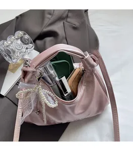 Top view of pink hobo bag showing large interior capacity with phone and cosmetics