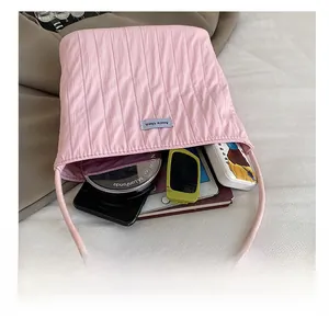 Pink pleated tote bag showing spacious interior with phone, sunglasses and daily items