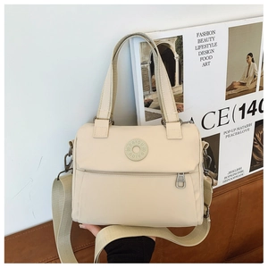 Detail of off-white nylon crossbody bag with rubber logo and silver metal hardware