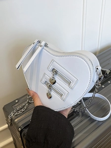Elegant white heart-shaped crossbody bag with multi-zipper design and silver chain strap