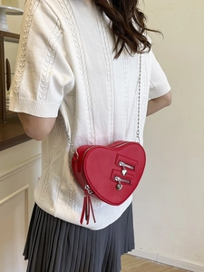 Chic red heart-shaped chain crossbody bag for women with decorative zippers and metal pulls