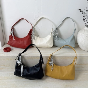 Detail view of five crescent hobo bags in various colors with metallic heart charms