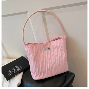 Close-up of pink pleated nylon shoulder bag with silver logo detail and slim handle