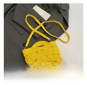 Detail view of the yellow hand-woven cotton rope bucket bag with hollow texture