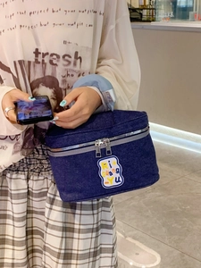 Large denim house-shaped cosmetic bag with blue handles and colorful embroidery