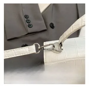 Detail showing high-quality silver metal hook and strap of the white faux crocodile bag