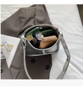 Spacious interior of silver metallic crossbody bag showing storage for daily essentials
