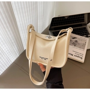 Detail of off-white crossbody bag with elegant pleats and silver metal twist lock