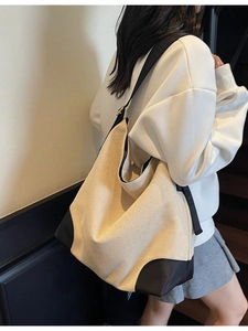 Minimalist beige canvas hobo tote bag with black trim for stylish women daily commute