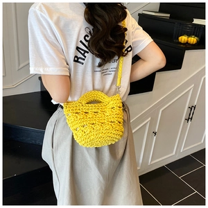 Detail of yellow knit bucket bag showing handmade thick cotton rope texture for summer