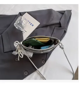 Internal view of silver crossbody bag showing spacious capacity for phone and wallet
