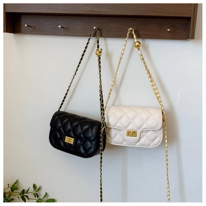 Detail of adjustable gold ball chain on black and beige quilted leather crossbody bags