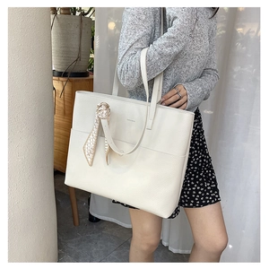Minimalist white lychee leather tote bag with silk scarf accessory and shoulder strap