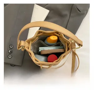 Top view of white leather bucket bag interior showing spacious storage for cosmetics