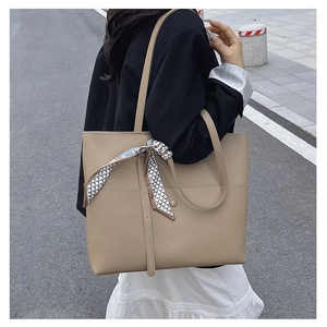 Chic beige tote bag in lychee texture with elegant silk scarf detail for office wear