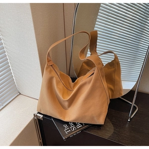 Dettaglio di una borsa tote marrone in tela con silhouette Hobo morbida per uso quotidiano