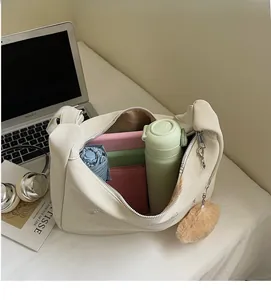 Detail showing the large interior capacity of the soft cream PU leather tote bag
