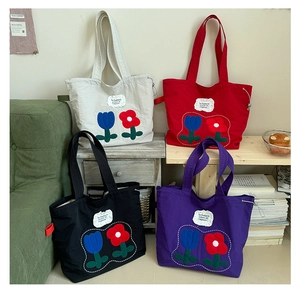 Set of four colorful canvas tote bags with tulip embroidery and minimalist cloth labels