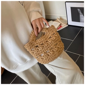Detailed close-up of khaki hand-woven bucket bag with hollow diamond knit pattern