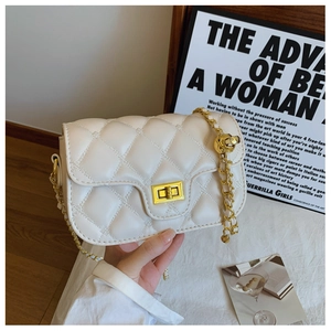 Detail of cream quilted leather shoulder bag with gold chain and rotary square lock