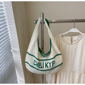Detailed knit tote bag with green embroidered letters and contrasting woven edges