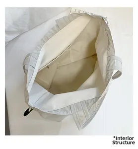 Interior view of grey tote bag with spacious main compartment and zippered inner pocket
