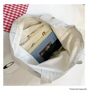 Top view of spacious white canvas tote bag interior with zipper pocket for daily storage