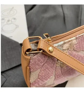 Detail of colorful sequins floral pattern and premium gold metal hardware on handbag