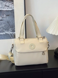 Chic beige nylon crossbody handbag with adjustable strap and front zipper pocket