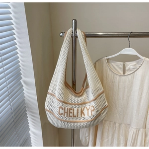 Detail of hollow knit tote bag with coffee trim and CHELI KYP letter pattern design