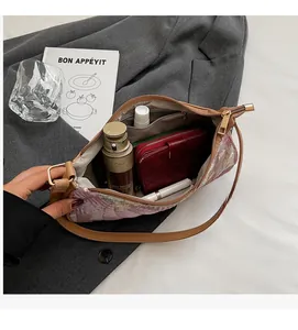 Detail view of the spacious inner compartment with lining and pockets of the floral bag