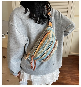 Detail of colorful woven crossbody bag with striped pattern and adjustable strap