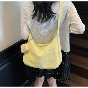 Detailed embroidery of cartoon cats and SO HAPPY text on yellow canvas crossbody bag