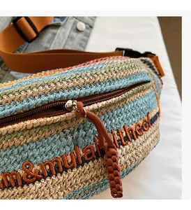 Detail of smooth zipper closure and colorful straw woven texture on a dumpling bag
