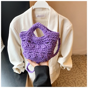 Close-up of purple crochet bucket bag showing thick cotton weave and texture