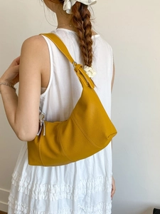 Yellow hobo shoulder bag with litchi grain leather and adjustable strap shown on model