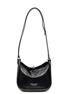 Minimalist black glossy leather crossbody bag with white branding and long shoulder strap