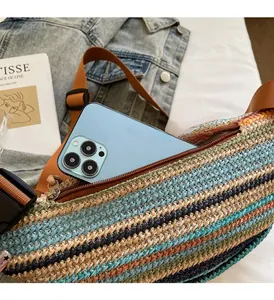 Detail of colorful woven dumpling bag featuring a zipper pocket for large smartphones