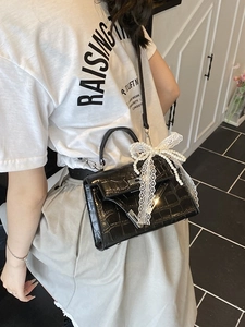 Black crocodile embossed Kelly bag with pearl lace bow and silver lock hardware
