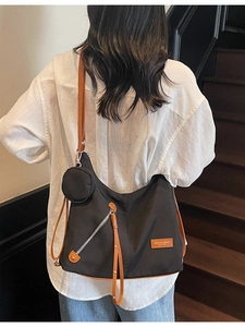 Large black nylon tote bag with brown leather straps and matching round coin purse