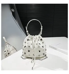 Detail of white铆钉 waterbucket bag with silver metal studs and sleek leather finish