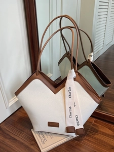 Minimalist creamy white tote bag with brown leather trim and stylish contrast straps