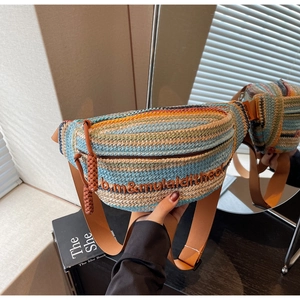Detail of colorful striped woven crossbody bag with hand-knitted zipper and embroidery