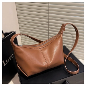 Close-up of brown PU leather hobo bag showing fine stitching and adjustable strap