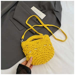 Detail showing bright yellow woven texture with sturdy handle and matching shoulder strap