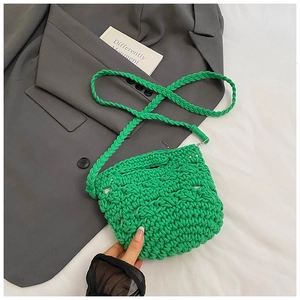 Detail of green hand-woven knit bucket bag with thick cotton rope and crochet texture