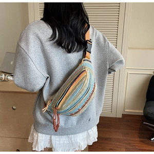 Detail of colorful woven crossbody bag with bohemian stripes and adjustable strap